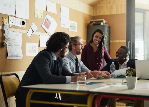 An office setting where diverse employees are collaborating on a project, highlighting the potential for career growth and development within the company through education.