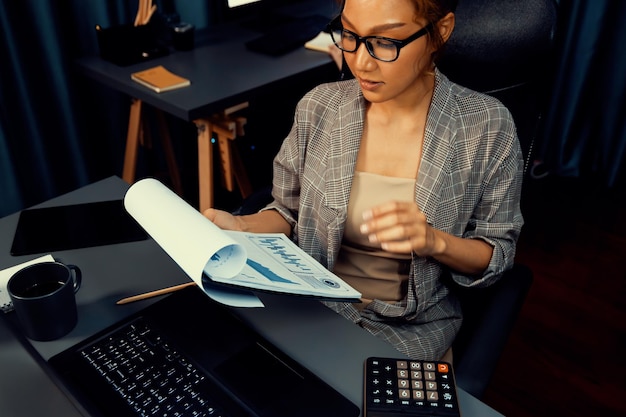 A person reviewing various tax documents, including forms related to property taxes and state tax returns, under a soft, focused light, symbolizing careful financial planning and tax preparation.
