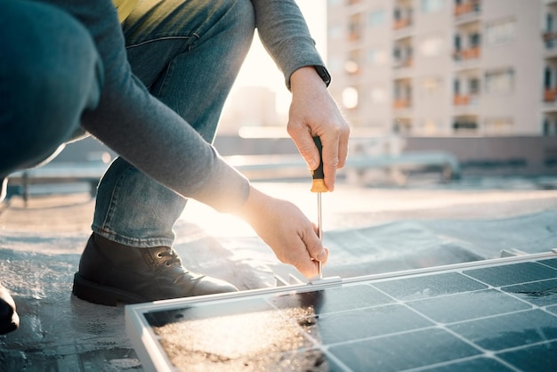 A close-up shot of a hand installing solar panels on a rooftop, emphasizing the practical application of renewable energy and the job creation aspect of the industry. Tools are visible, suggesting the skilled labor involved in deploying these technologies.