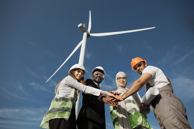 A diverse group of workers assembling wind turbine blades in a factory, symbolizing the job creation and economic benefits of renewable energy. The atmosphere is clean and modern, reflecting the advanced technology used in the industry.